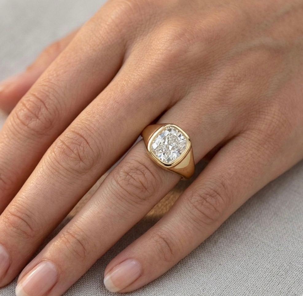 Gold diamond ring on a women’s finger. Made in Cornwall.