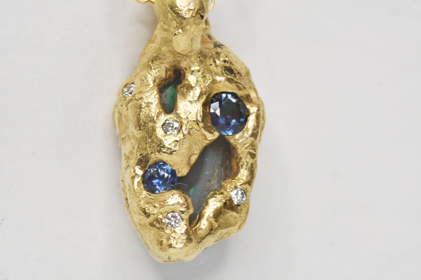 1.15ct Black Opal, White Diamond and Sapphire pendant, 18k Yellow Gold. St Ives, Cornwall.