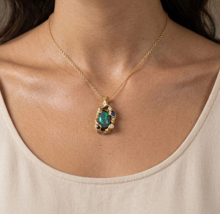 Necklace with a green gemstone pendant worn by a person. Pendant made in St Ives Cornwall. Shem Hake Jewellery. 