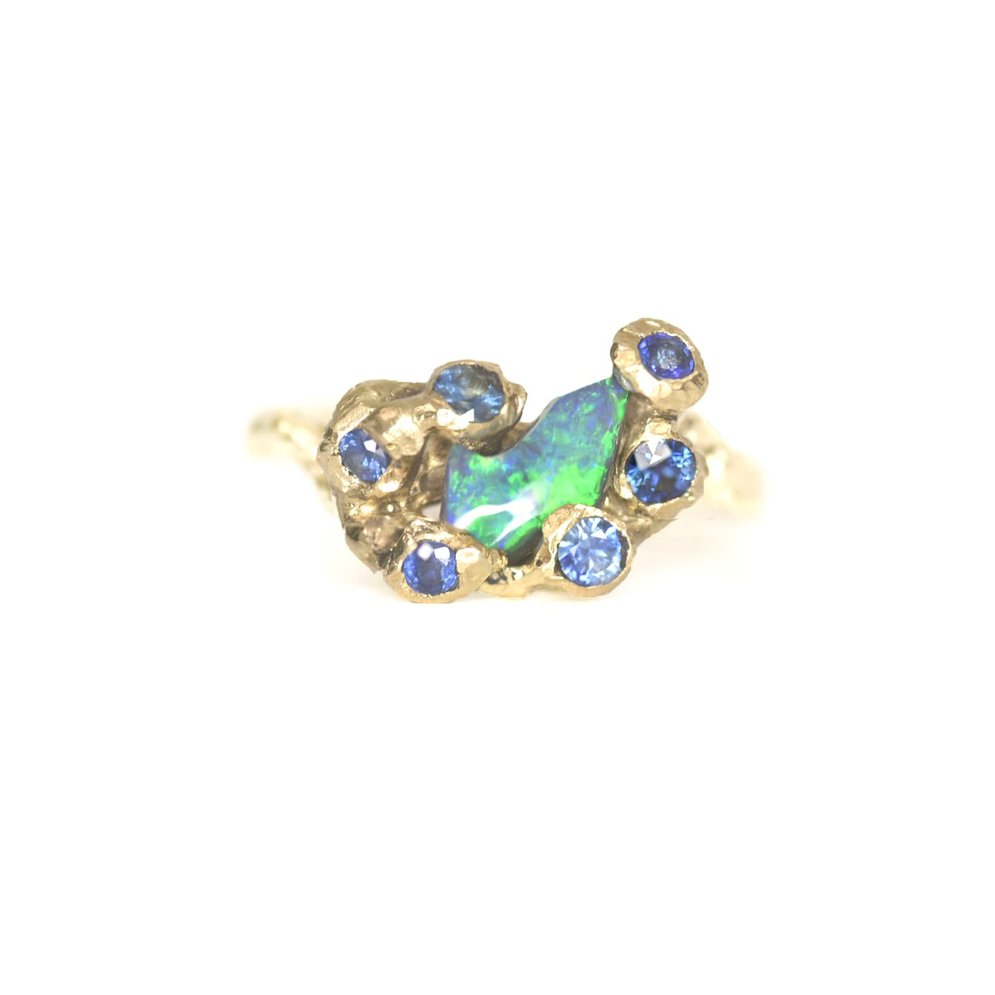 Organic 9k gold ring with black opal and blue sapphires inspired by St Ives, Cornwall. On a white background. 