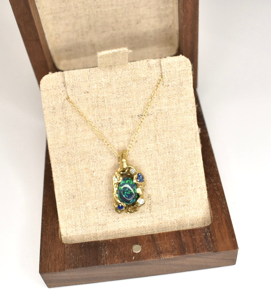 2.4 ct Black Opal, White Diamond, Cognac Diamond and Sapphire Ring. 18k Yellow Gold Pendant. Western Cliffs of Swanage.