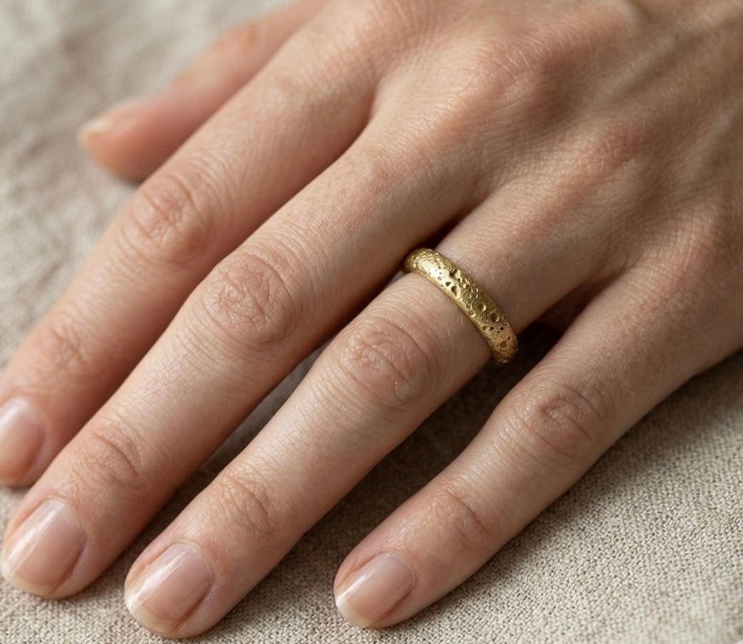 Gold ring with a textured surface, sand cast wedding ring. Made in Cornwall.