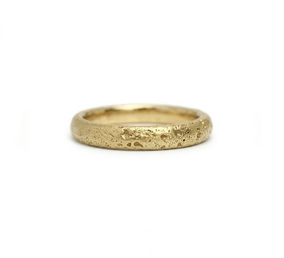 Gold ring with a textured surface, sand cast wedding ring. Made in Cornwall. 