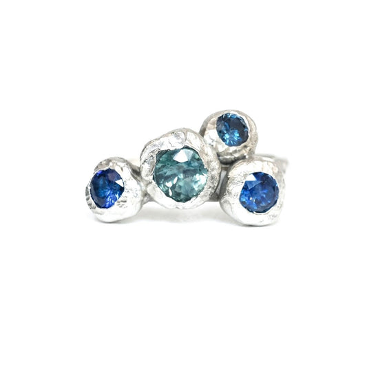 Silver organic ring with big sapphires. On a white background. Inspired by the Peak District. 