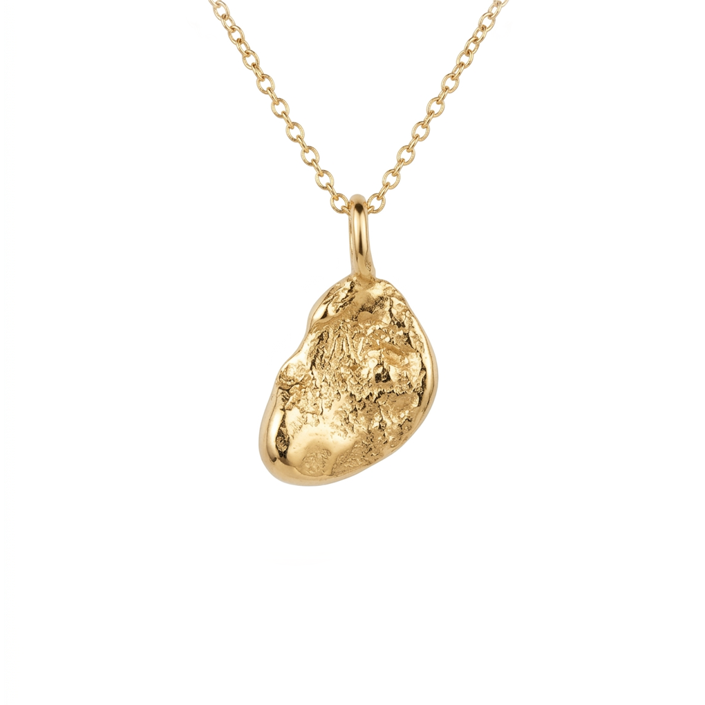 Gold pendant necklace on a white background. Jewellery made on the beach in Cornwall. 