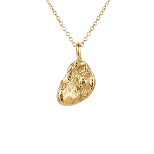 Gold pendant necklace on a white background. Jewellery made on the beach in Cornwall. 