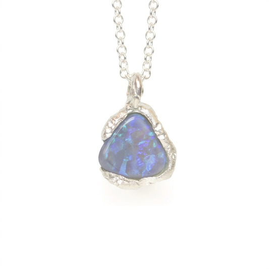 Triangular opal pendant on a silver chain against a white background. Jewellery made in the highlands of Scotland, on the summit of Ben Lomond. 