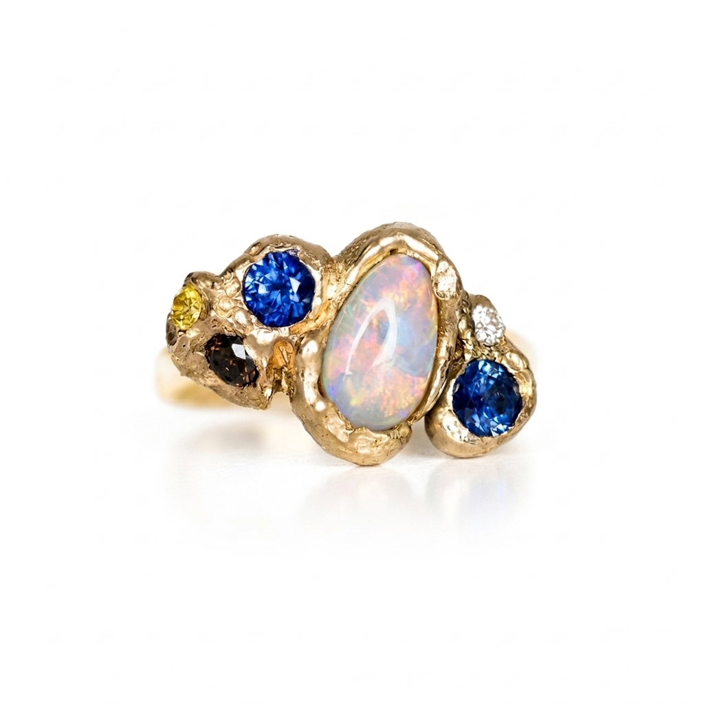 14k yellow gold, white lol, sapphire and diamond ring. On a white background. 
