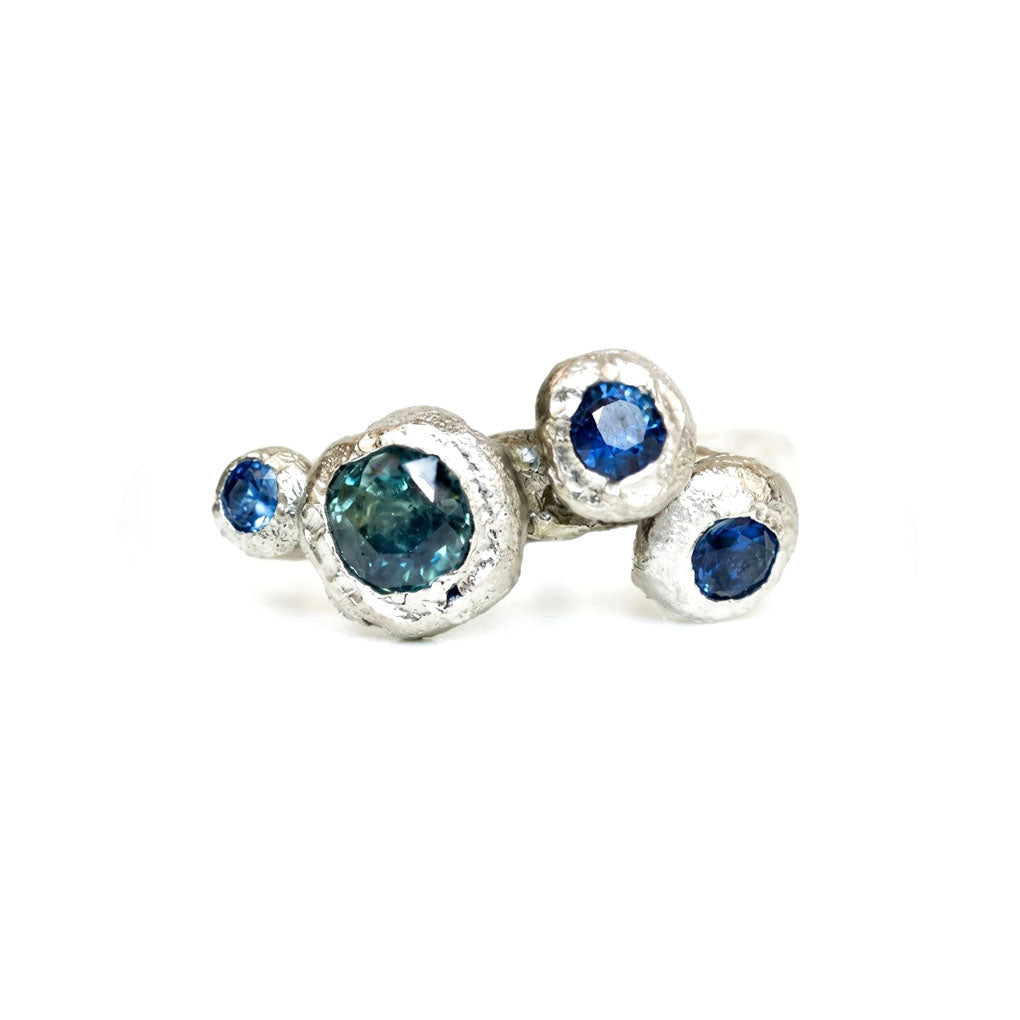 Silver ring with blue gemstones on a white background. Metal cast on top of kinder Scout in the Peak District. 
